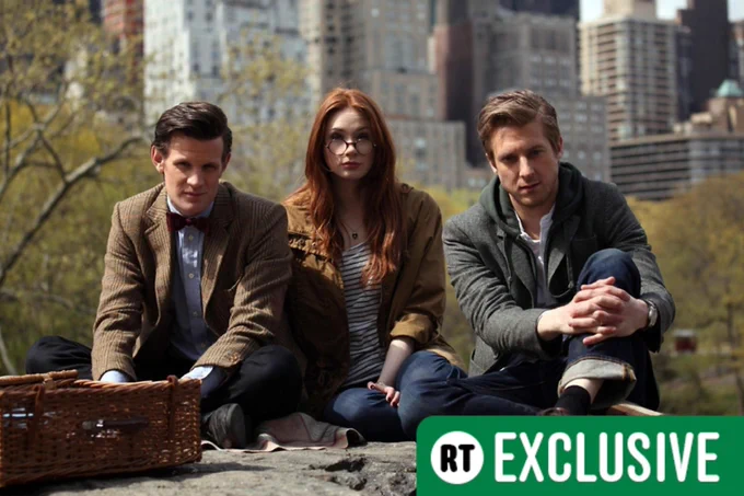 Matt Smith as the Tenth Doctor, Karen Gillan as Amy Pond, Arthur Darvill as Rory Williams in Doctor Who, sitting down. There's an RT Exclusive banner in the bottom corner.