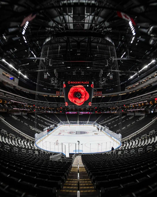 An Empty Rogers Place with a large poppy displayed on the jumbotron.