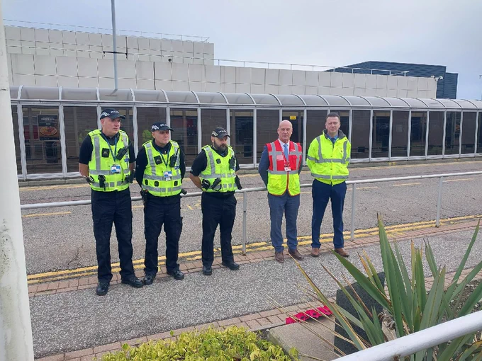 Airport Police Officers and Airport Staff pay their respects in a minute silence.