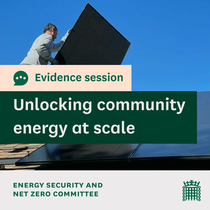 Evidence session, Unlocking community energy at scale. 
Energy Security and Net Zero Committee. 
Photo shows a man fitting solar panels on the roof of a house.