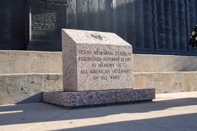 Close-up view of the Texas Memorial Stadium dedication plaque honoring American veterans of all wars.