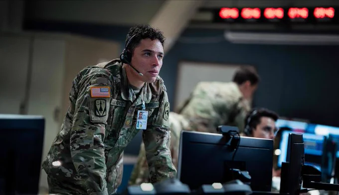 Terrified operator in a command centre surrounded by consoles