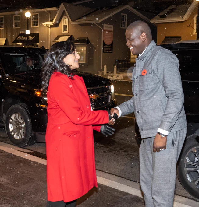 Minister Anand shaking hands with Ronald Lamola, South Africa’s Minister of International Relations and Cooperation, outside.