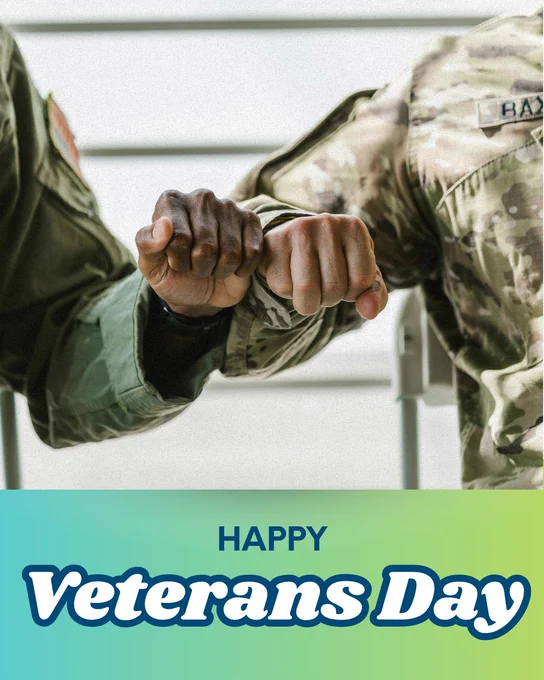 Two people in military uniforms fist-bumping each other. Under this image is text that reads “Happy Veterans Day” over a teal-to-green gradient.
