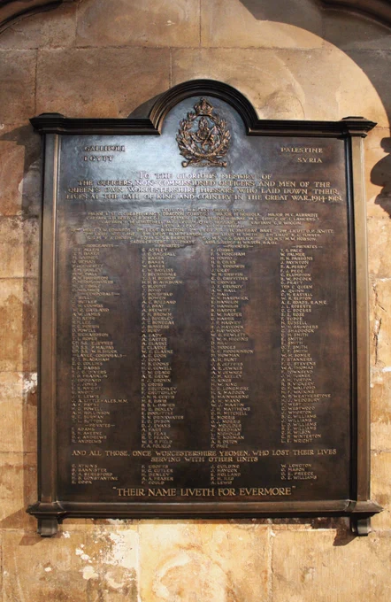 The First World War memorial plaque for the Queen's Own Worcestershire Hussars in Worcester Cathedral made of brass with their badge at the top and the names of all those who died during the war.