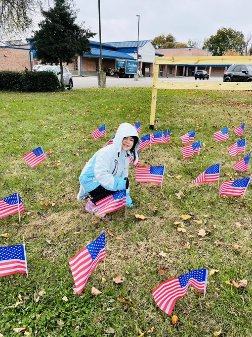 Girl putting a flag in the ground