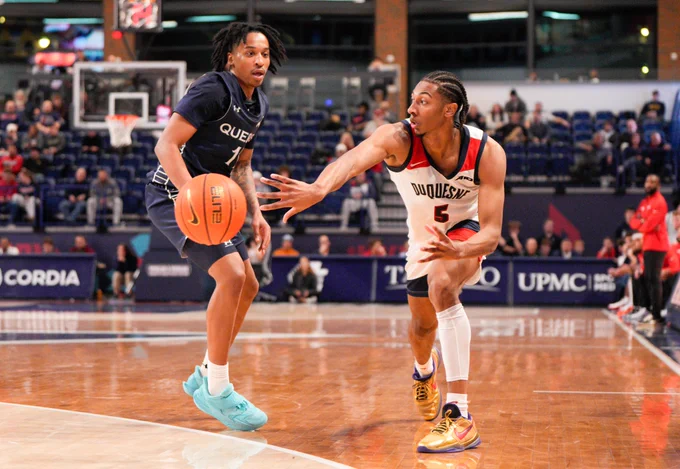 Redshirt senior guard Cam Crawford passes the ball Tuesday against Queens at UPMC Cooper Fieldhouse as part of the Villanova Challenge.