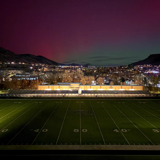 The field of Marv Kay Stadium with the aurora borealis behind it