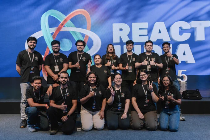 React india team organizers in a group picture in front of a massive curved led display