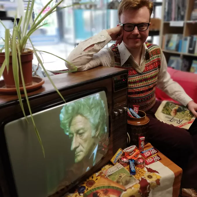 Actor Ethan Warren with a vintage 1970s TV set 