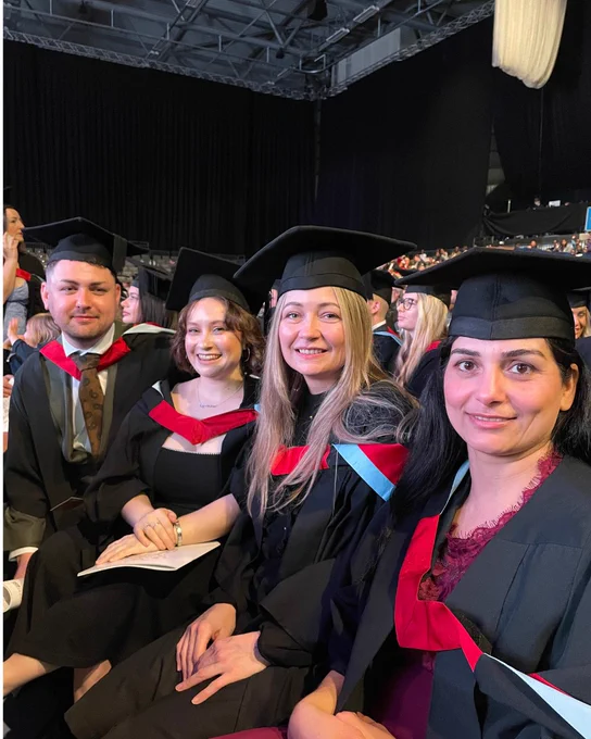 Four friends are sat waiting for their graduation ceremony at Derby Arena