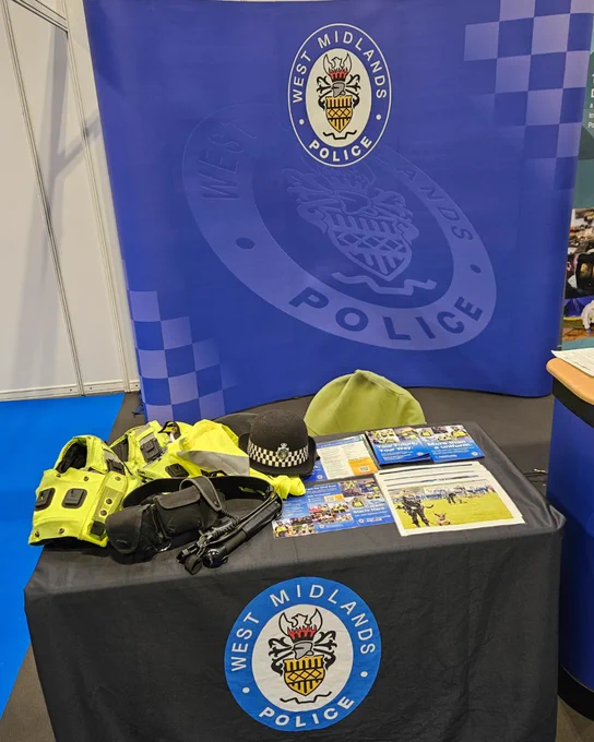 The set up for the event with the uniform, banner and table with a West Midlands Police table cloth.