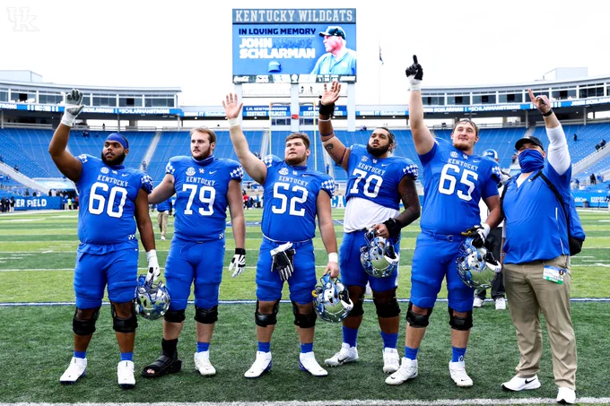 Offensive line waving to John Schlarman's family. 