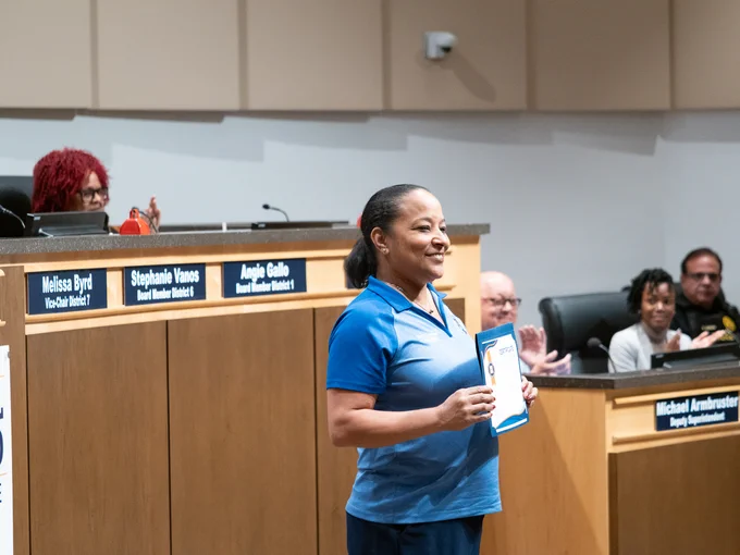 Principal melanie simmons at school board meeting after simmons is recognized