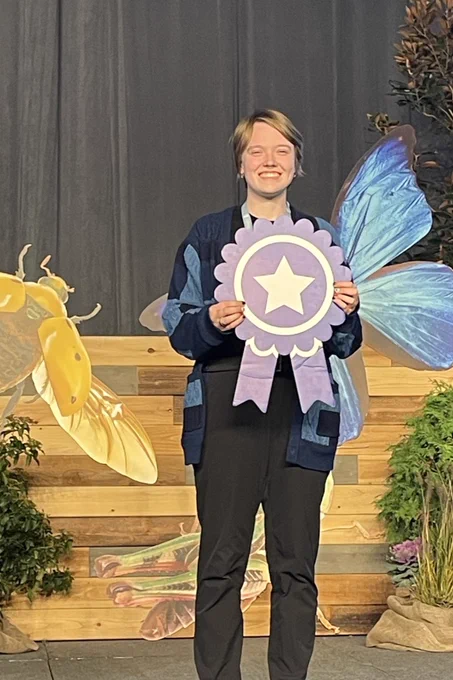 Claire Garman, a second-year PhD student in the IPID graduate program at UNMC, holding award at the Entomological Society of America's annual meeting 11/12 in Portland, Oregon