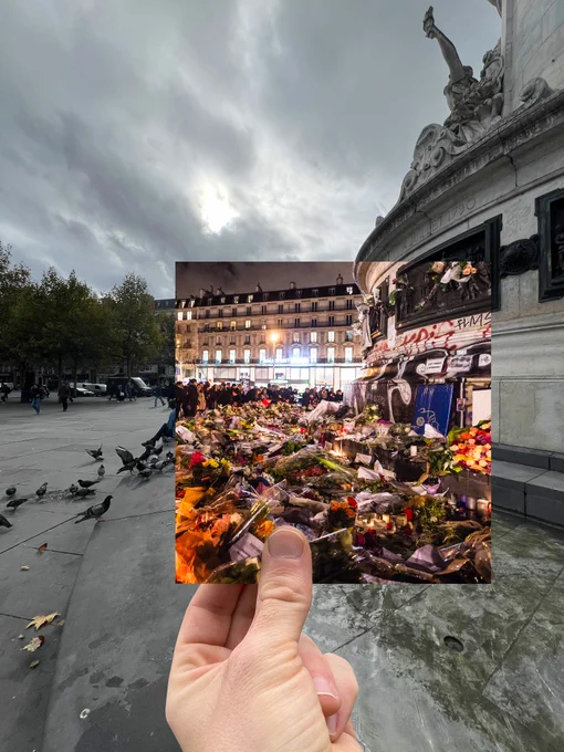 Photo d’une photo prise quelques jours après le 13 novembre 2015, replacée au même endroit dix ans plus tard : des centaines de fleurs déposées au pied de la Statue de la République, à Paris, entourées de personnes venues rendre hommage