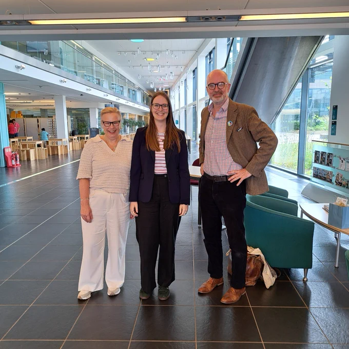 Three people smiling at the camera