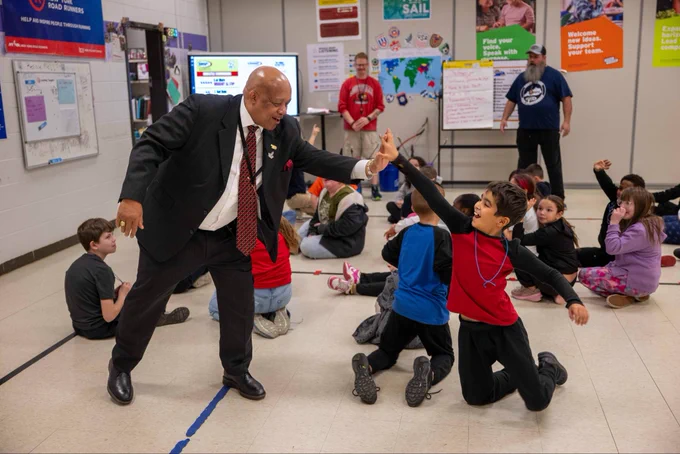 Dr. Yearwood giving a student a high 5.