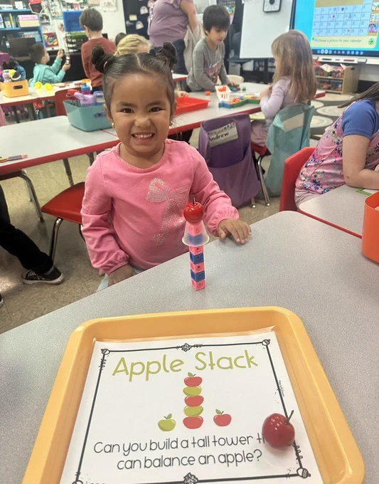 Student with an apple stack