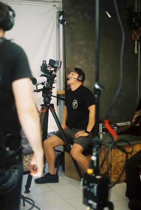 Erik operating a camera on a tripod 