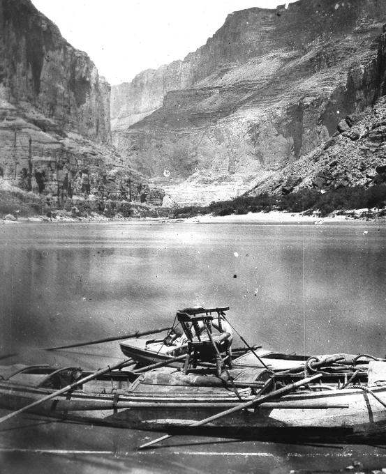 A black and white photo taken in 1872 of John Wesley Powell's famous wooden armchair boat on the Colorado River in Grand Canyon National Park. USGS Photo Library.