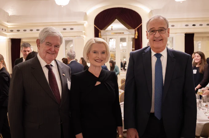 Ambassador Callista L. Gingrich and Speaker Newt Gingrich pose for a photo with Vice President Guy Parmelin at a formal dinner event.