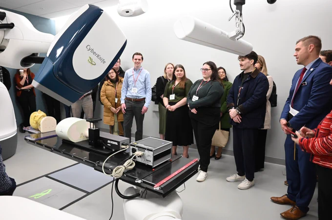 Congressional staff and UW–Madison leaders watch a demo of Accuray's CyberKnife radiotherapy equipment
