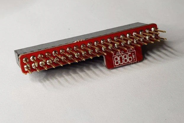 A small red PCB soldered onto a 2x20 header with long pins. There's a small section which sticks out with the 8086.net logo and "Fake HAT" text.