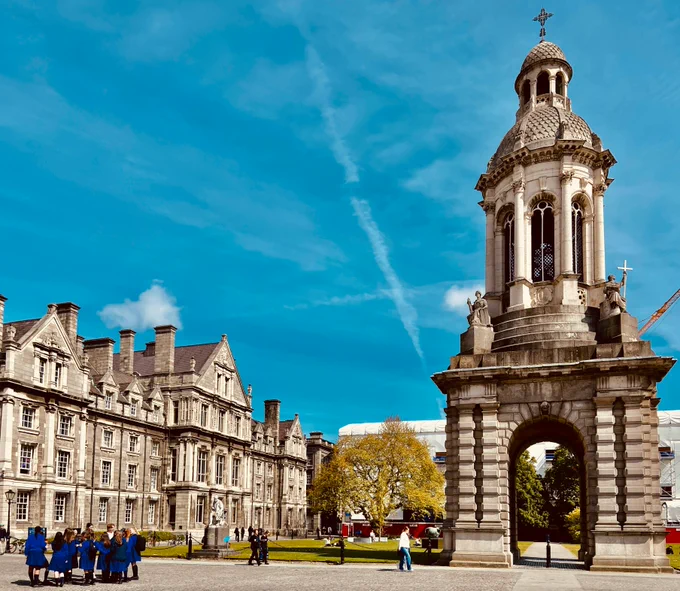 Trinity's campanile in Front Square against a brightness-enhanced blue sky background.
