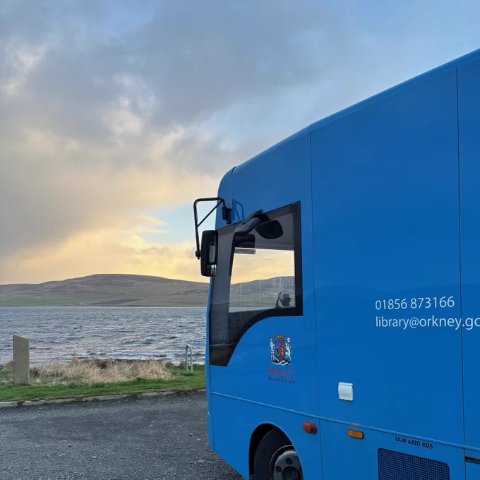 BookyMcBookface our Mobile Library parked up beside the sea