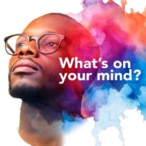 A man looking off the frame to the left with "What's on your mind? written in white font in the foreground
