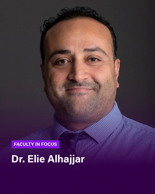 A headshot of a man in a tie smiling against a dark backdrop. A light gradient fades into dark purple at the bottom of the image, over which text reads: FACULTY IN FOCUS Dr. Elie Alhajjar