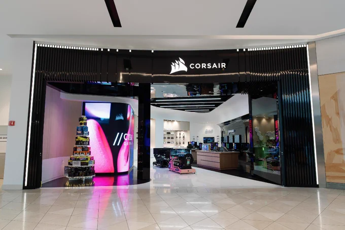 The entrance to the CORSAIR Experience Store at Westfield Valley Fair in Santa Clara, CA, featuring vibrant lighting and display of various products.