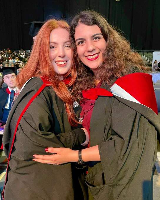 Two friends hug during the University of Derby graduation ceremony