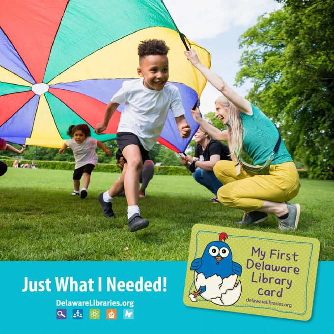 Children running under colorful parachute outside with Just What I Needed in bold text under it with an image of a Delaware Libraries My First Library Card with Baby Blue on it.