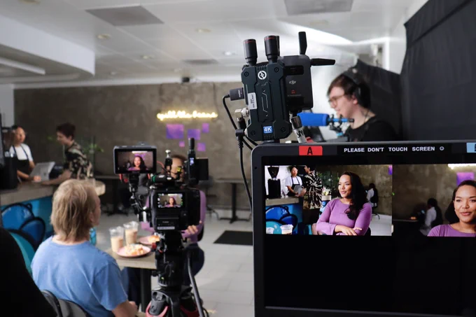 A frame showing the camera on the left side of the screen and the monitor on the right side, with our lead actor on the screen. 