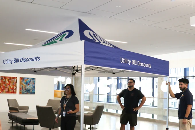 Austin Energy employees set up a tent for a community fair.