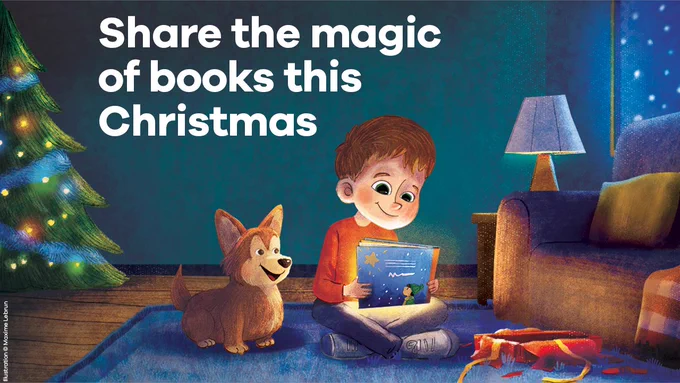 An illustration of a boy sitting on the floor of a room holding a glowing book and smiling, watched on by a smiling dog. A Christmas tree is on the left, while snow falls outside, and an unwrapped gift box is on the floor next to the boy. Plus the words: "Share the magic of books this Christmas"