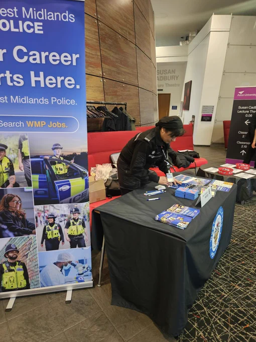 PC Begum setting up the table with leaflets