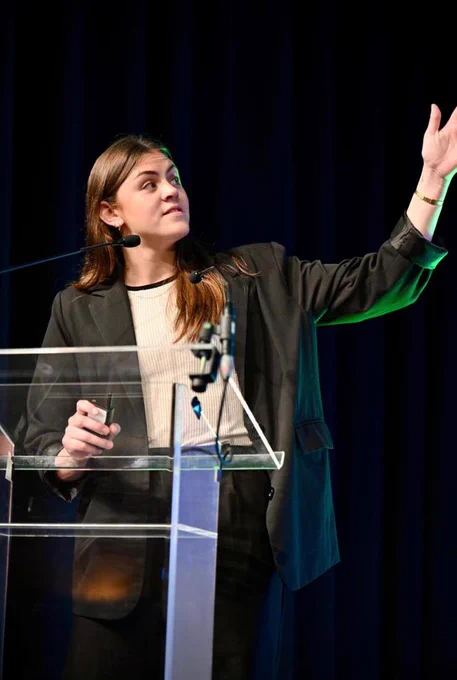 a person speaking at a podium 