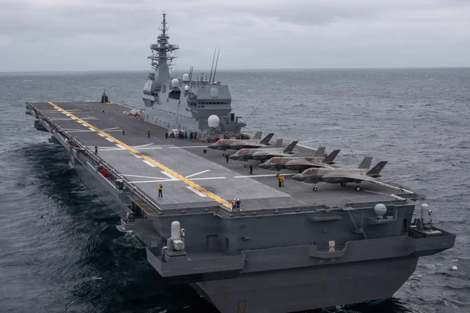 U.S. Marines assigned to Marine Fighter Attack Squadron 242, Marine Aircraft Group 12, 1st Marine Aircraft Wing, Sailors with the USS Tripoli, Task Force 76, and Japan Maritime Self-Defense Force members with the JS Kaga prepare to launch F-35 B Lightning II Aircraft aboard the JS Kaga during exercise ANNUALEX Oct.19, 2025. The exercise supports both force’s mission to strengthen interoperability, enhance joint maritime strike capabilities and maintain readiness in support of a free and open Indo-Pacific. (U.S. Marine Corps photo by Cpl. Alejandra Vega)