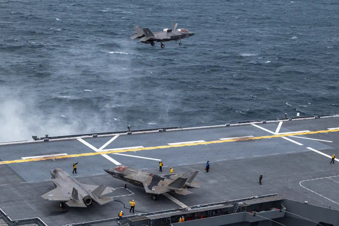 A U.S. Marine Corps F-35B Lightning II aircraft with Marine Fighter Attack Squadron (VMFA) 242, Marine Aircraft Group 12, 1st Marine Aircraft Wing, hovers over the JS Kaga during exercise ANNUALEX Oct.19, 2025. The exercise supports both force’s mission to strengthen interoperability, enhance joint maritime strike capabilities and maintain readiness in support of a free and open Indo-Pacific. (U.S. Marine Corps photo by Cpl. Alejandra Vega)