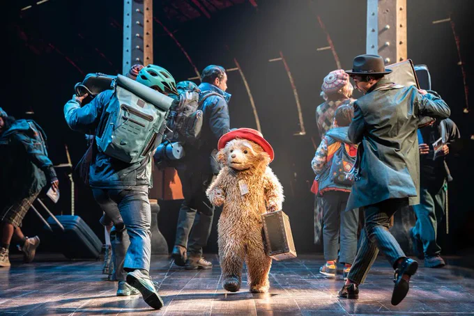 A photo showing a performer dressed as a bear on a stage 