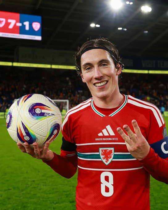 Harry Wilson with the match ball and holding up three fingers after scoring a hat-trick against North Macedonia. 