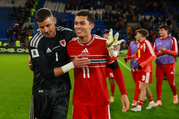 Karl Darlow and Brennan Johnson celebrate Cymru's 7-1 win over North Macedonia.