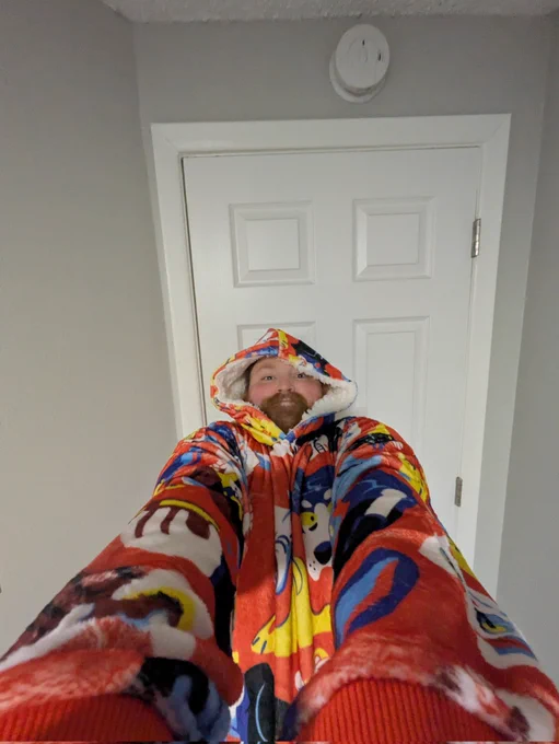 A totally normal selfie taken at a downward angle. It's actually not totally normal. I lied. I am in a hooded blanket. I zoomed the camera distance to .5 and leaned back with both arms extended. It's distracting. This should be the new selfie standard.