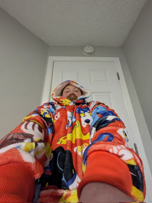 A totally normal selfie taken at an upward angle. It's actually not totally normal. I lied. I am in a hooded blanket. I zoomed the camera distance to .5 and leaned back with both arms extended. It's distracting. This should be the new selfie standard.