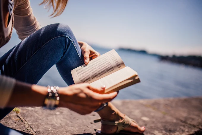 Someone reading a book outdoors