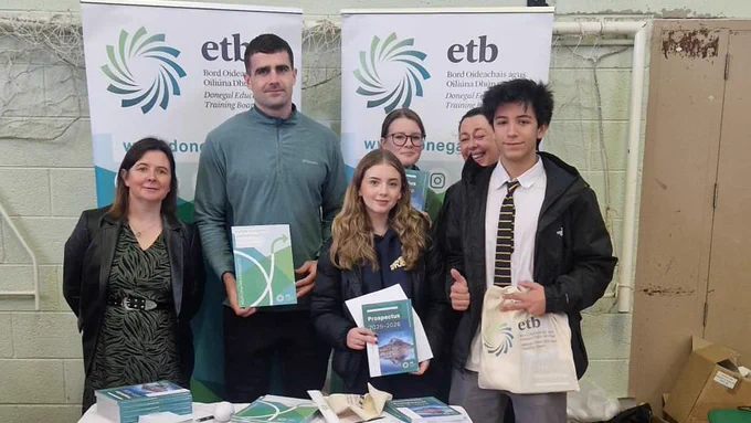 Group of people at an information desk. 