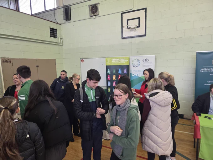 Group of people at an information desk. 